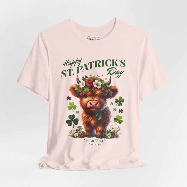 St. Patrick's Day Graphic Tee featuring a highland baby cow with flowers and clovers.