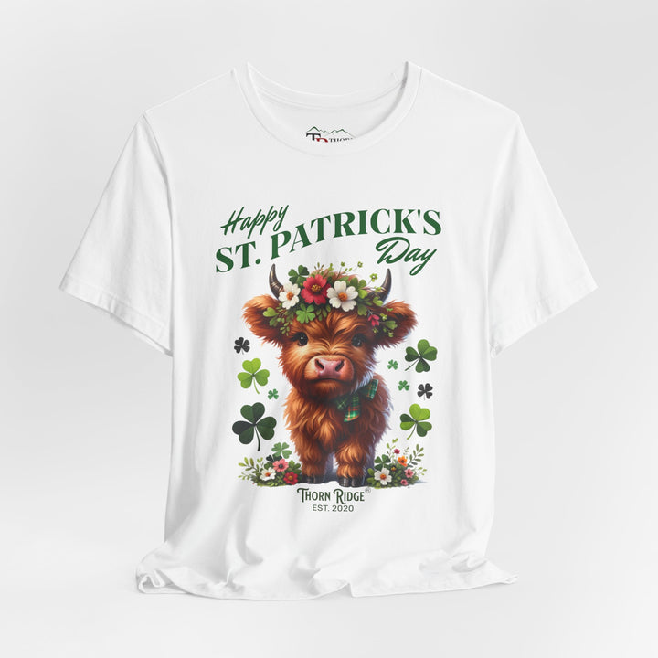 St. Patrick's Day Graphic Tee featuring a highland baby cow with flowers and clovers.