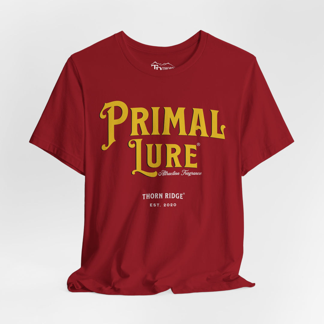 t-shirt with the text 'PRIMAL LURE' in bold yellow letters and 'THORN RIDGE EST. 2000' in smaller text below it.