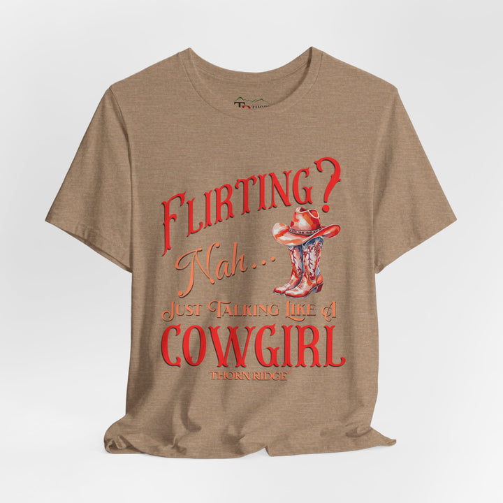 "Flirting? Nah... just talking like a cowgirl" graphic tee with women's cowgirl boots with a cowgirl hat sitting on top. Labeled Thorn Ridge®