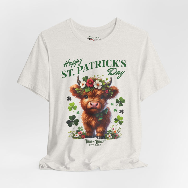 St. Patrick's Day Graphic Tee featuring a highland baby cow with flowers and clovers.
