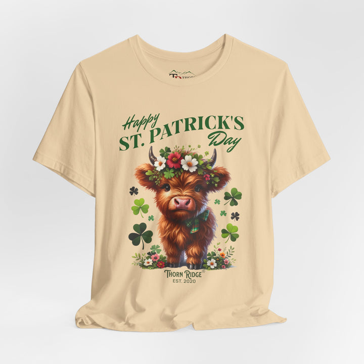 St. Patrick's Day Graphic Tee featuring a highland baby cow with flowers and clovers.