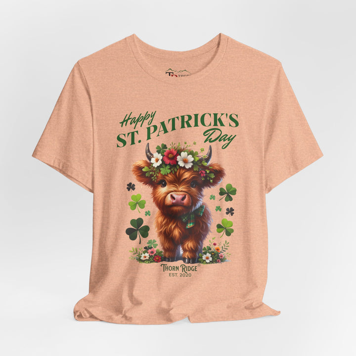 St. Patrick's Day Graphic Tee featuring a highland baby cow with flowers and clovers.