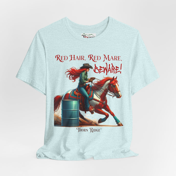 t-shirt with a graphic of a redhead woman on a horse barrel racing and the text 'Red Hair, Red Mare, Beware!' labeled Thorn Ridge®.