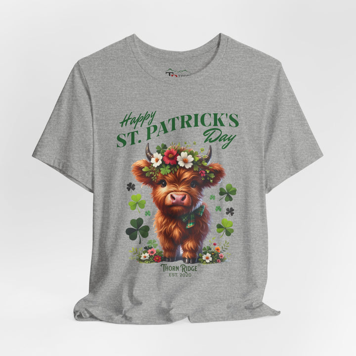 St. Patrick's Day Graphic Tee featuring a highland baby cow with flowers and clovers.