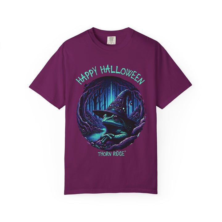 Happy Halloween from The Frog Witch labeled Thorn Ridge. Frog with a witches hat sitting by a dark stream in a wicked forest.