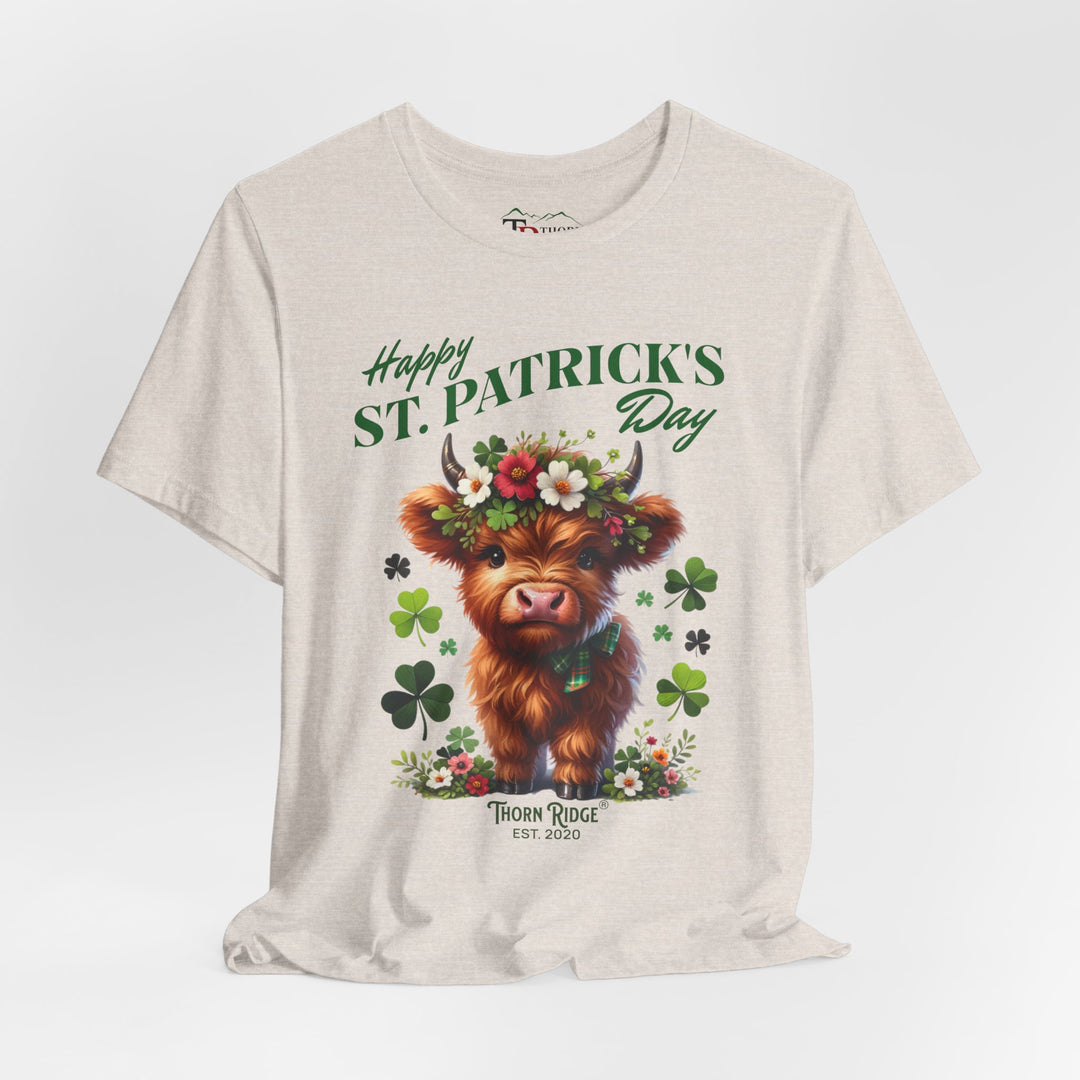 St. Patrick's Day Graphic Tee featuring a highland baby cow with flowers and clovers.