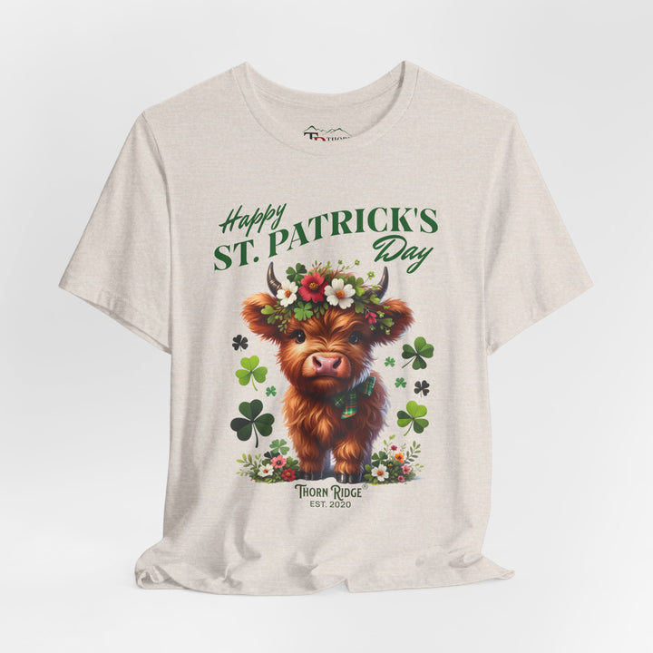 St. Patrick's Day Graphic Tee featuring a highland baby cow with flowers and clovers.
