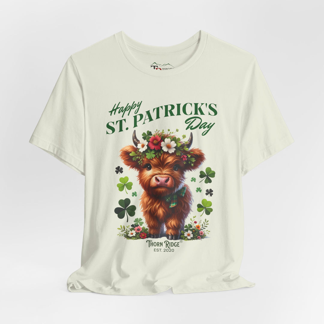 St. Patrick's Day Graphic Tee featuring a highland baby cow with flowers and clovers.