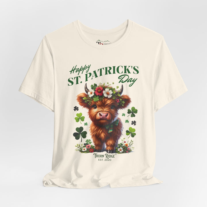 St. Patrick's Day Graphic Tee featuring a highland baby cow with flowers and clovers.
