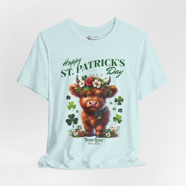 St. Patrick's Day Graphic Tee featuring a highland baby cow with flowers and clovers.