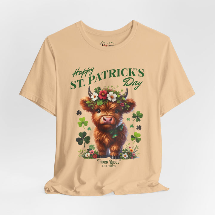 St. Patrick's Day Graphic Tee featuring a highland baby cow with flowers and clovers.
