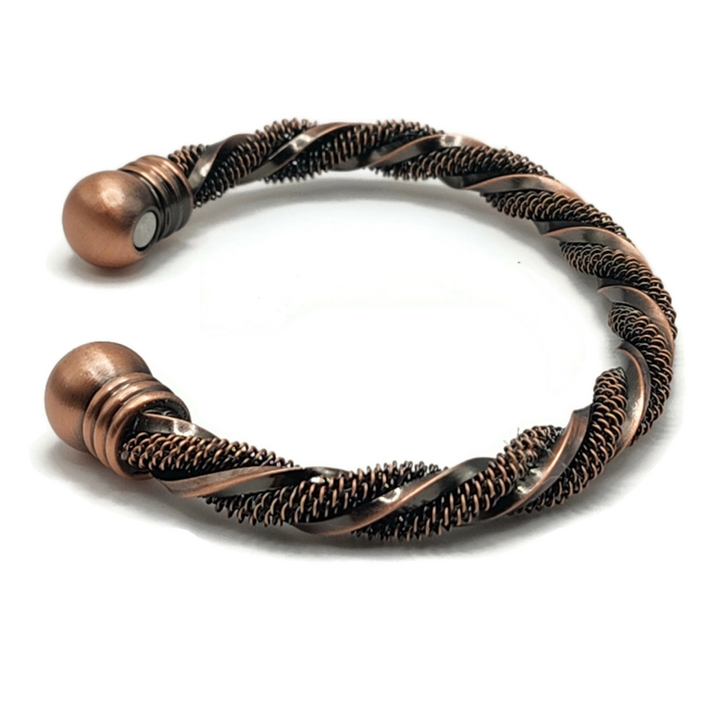 Brass twisted bangle bracelet with a manget on each end. One section of brass is textured and the other is smooth.