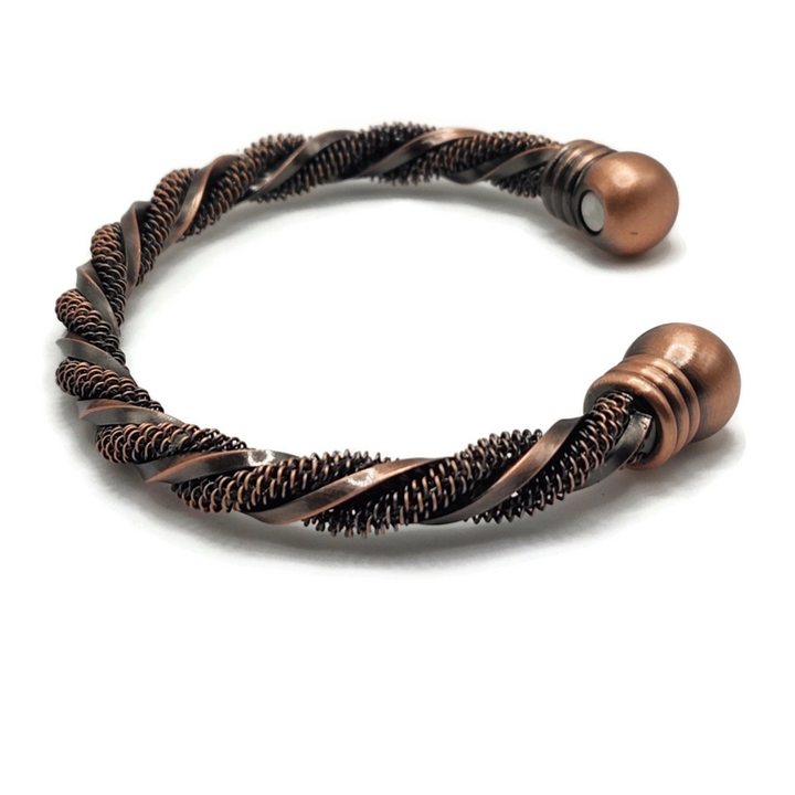Brass twisted bangle bracelet with a manget on each end. One section of brass is textured and the other is smooth.