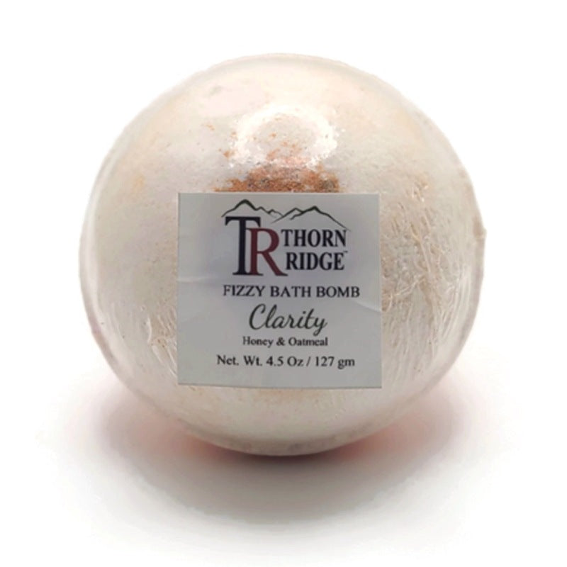 A Thorn Ridge fizzy bath bomb labeled "Clarity," described as a honey and oatmeal fragrance. 4.5 oz.