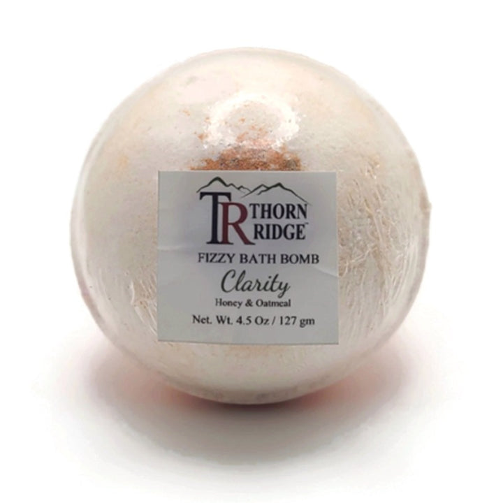 A Thorn Ridge fizzy bath bomb labeled "Clarity," described as a honey and oatmeal fragrance. 4.5 oz.