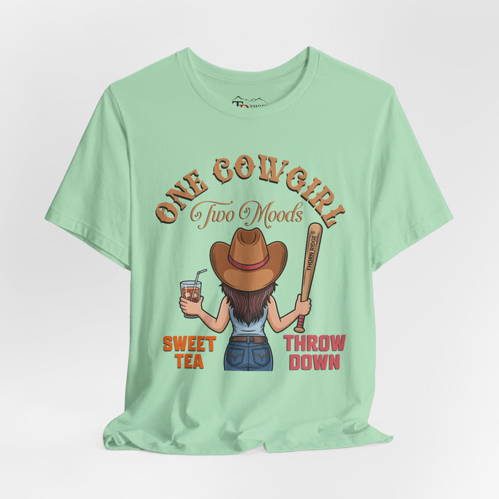 t-shirt with a graphic of a cowgirl holding a drink and a bat, with text 'One Cowgirl Two Moods Sweet Tea Throw Down' labeled Thorn Ridge®