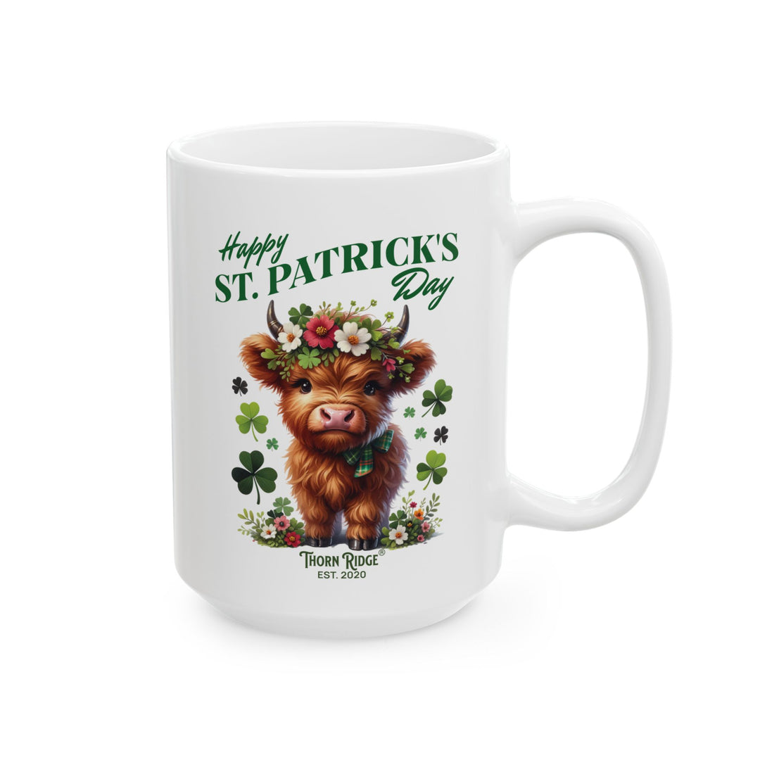 White mug with a design of a highland cow wearing a flower crown, surrounded by shamrocks, and 'Happy St. Patrick's Day' and Thorn Ridge®