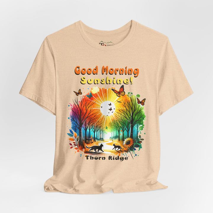 good morning sunshine graphic tee by Thorn Ridge featuring the sun shining through the trees and two cats walking across the path in a park.