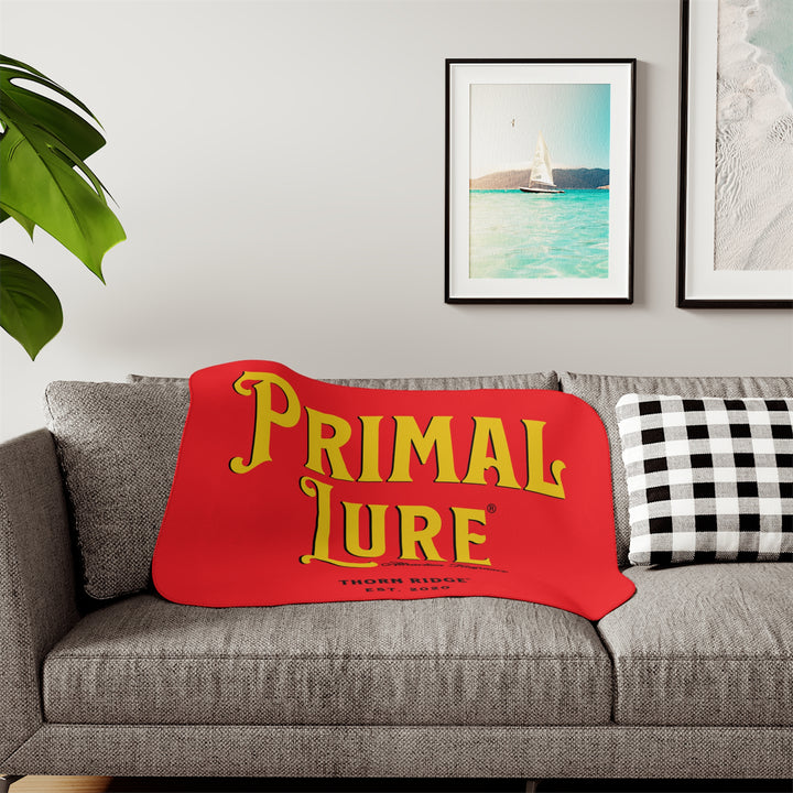 Prinmal Lure Attraction Fragrance by Thorn Ridge® in gold on a red sherpa blanket