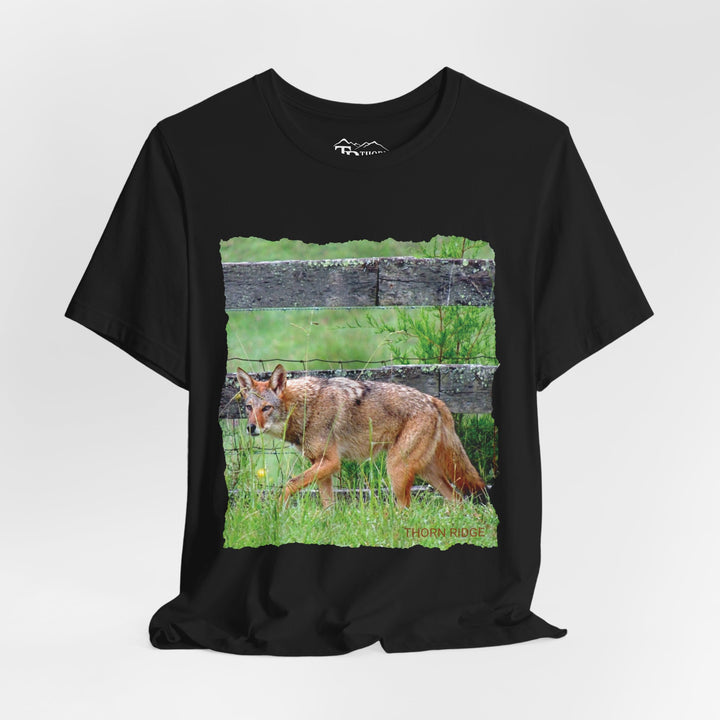 t-shirt with a photo of a red coyote against a weathered board fence and green grass labeled Thorn Ridge®