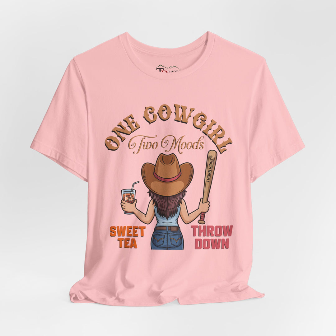 t-shirt with a graphic of a cowgirl holding a drink and a bat, with text 'One Cowgirl Two Moods Sweet Tea Throw Down' labeled Thorn Ridge®