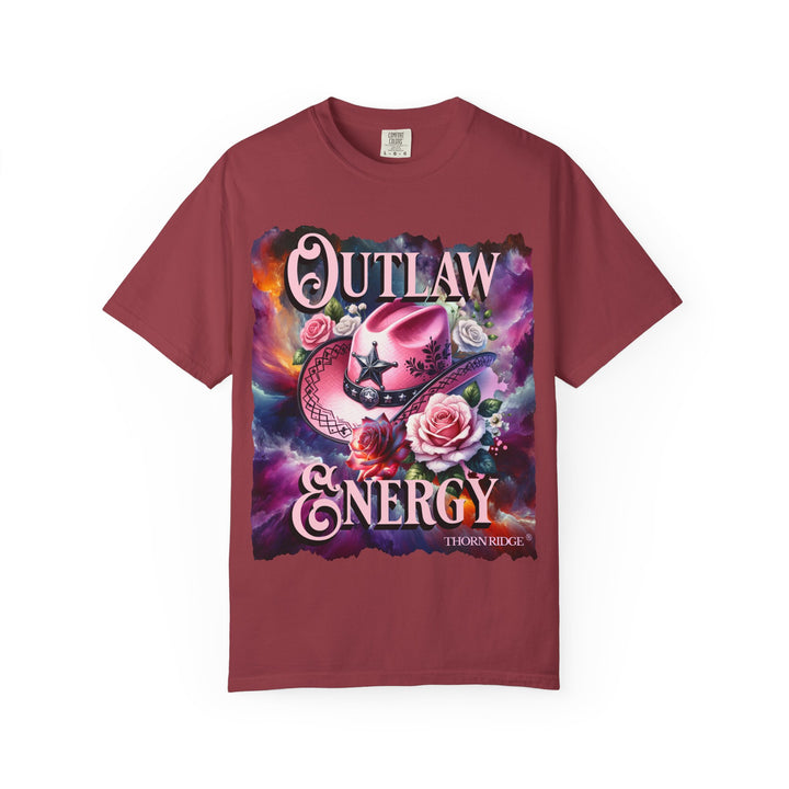 Outlaw Energy graphic tee with a pink cowgirl hat and roses on a celestial background of pinks, blues, and oranges. Labeled Thorn Ridge®