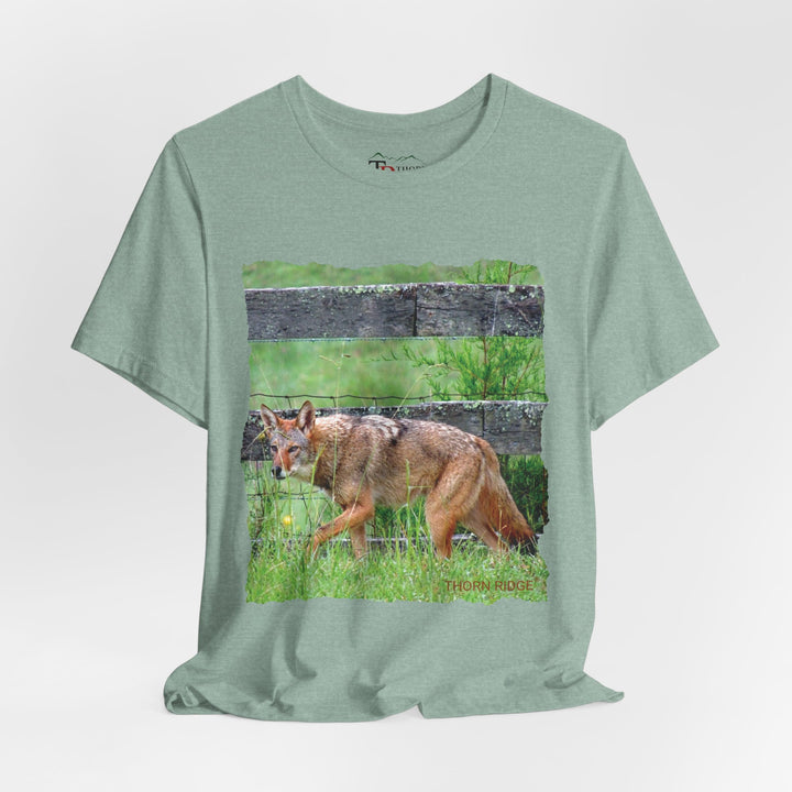 t-shirt with a photo of a red coyote against a weathered board fence and green grass labeled Thorn Ridge®