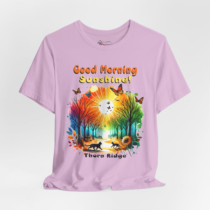 good morning sunshine graphic tee by Thorn Ridge featuring the sun shining through the trees and two cats walking across the path in a park.