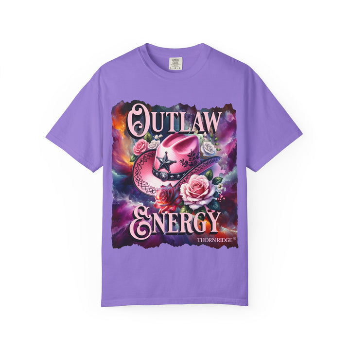 Outlaw Energy graphic tee with a pink cowgirl hat and roses on a celestial background of pinks, blues, and oranges. Labeled Thorn Ridge®