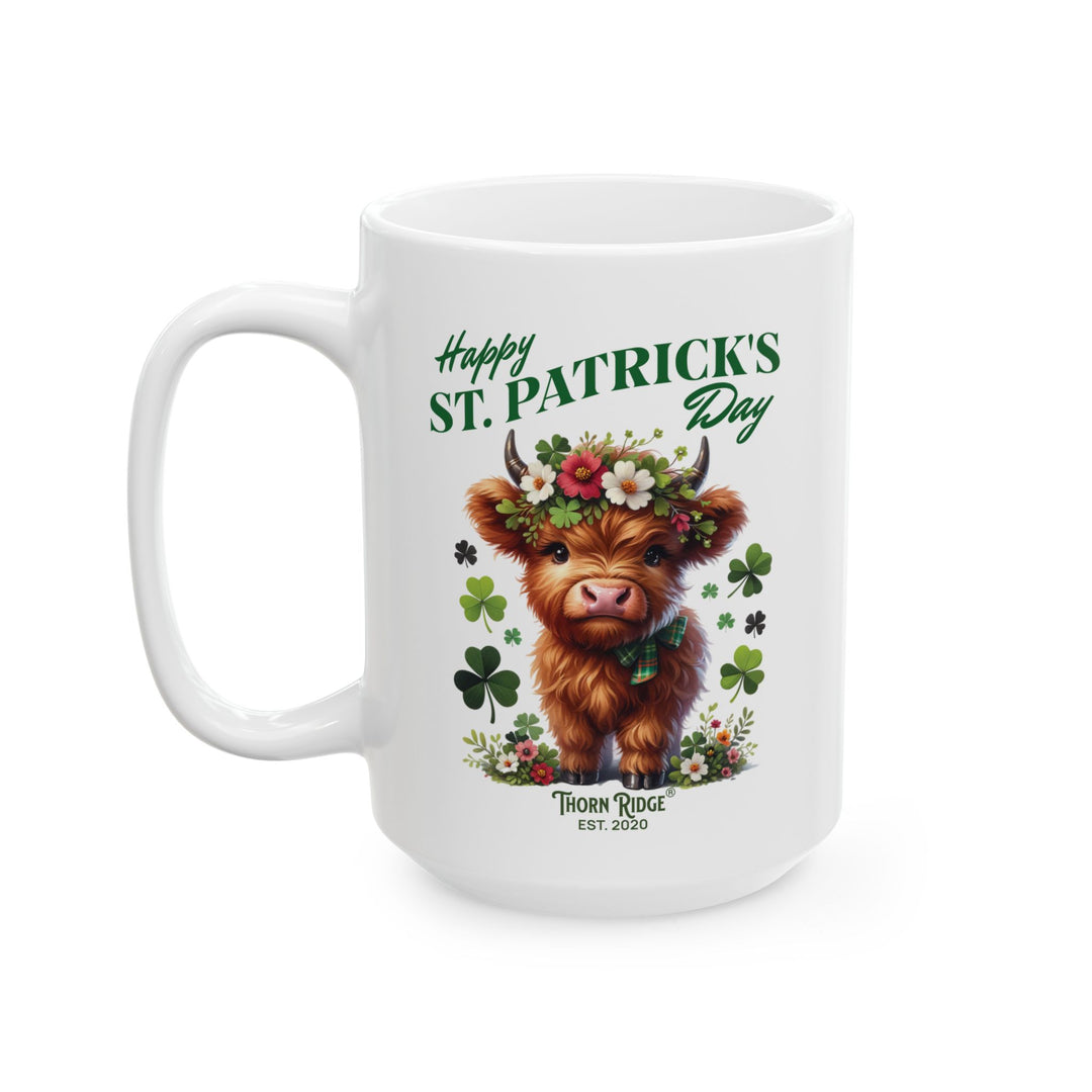 White mug with a design of a highland cow wearing a flower crown, surrounded by shamrocks, and 'Happy St. Patrick's Day' and Thorn Ridge®