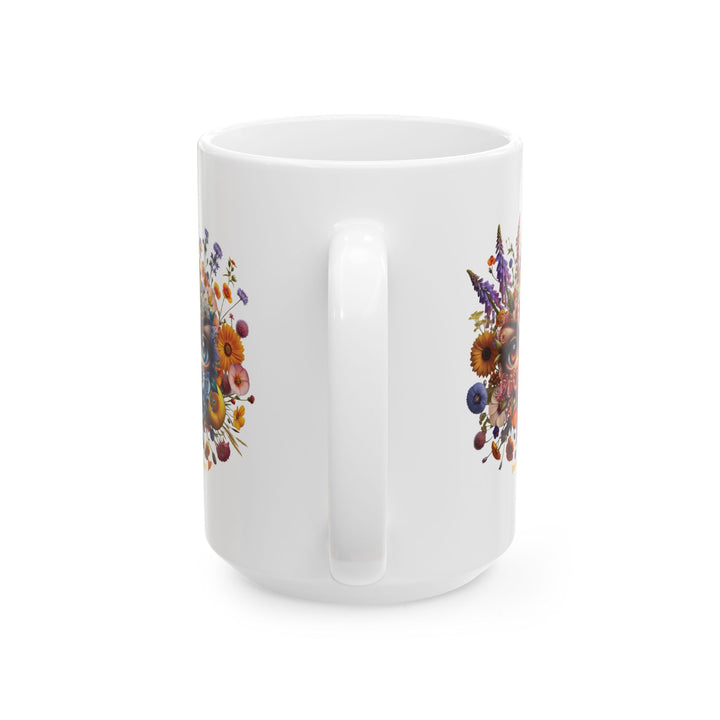 White mug You've Been Gazed with a colorful floral design with eyes gazing out at you from the middle of the flowers and 'Thorn Ridge' branding on a white background