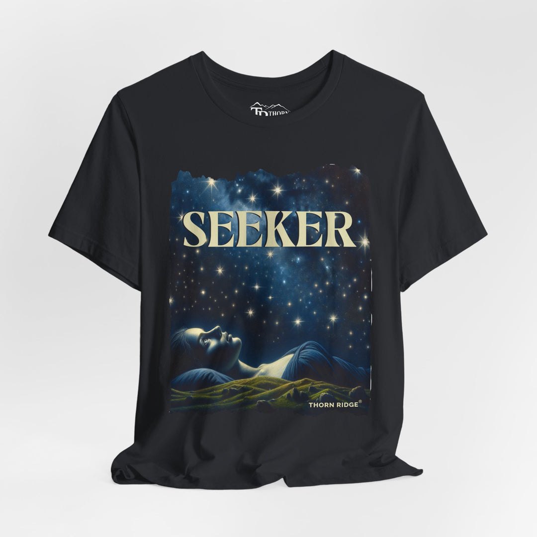 t-shirt labeled Seeker with the graphic of a woman laying on her back looking at the stars labeled Thorn Ridge®