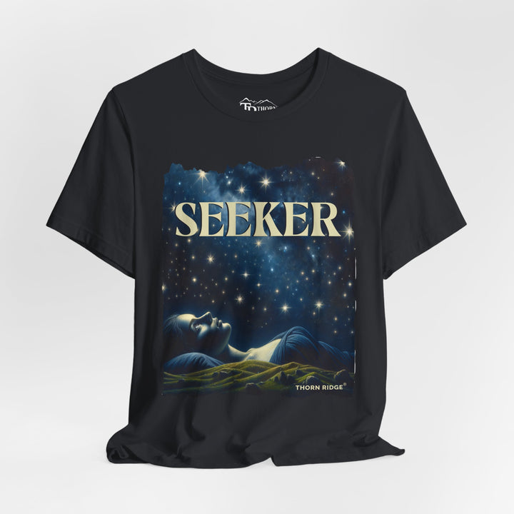 t-shirt labeled Seeker with the graphic of a woman laying on her back looking at the stars labeled Thorn Ridge®