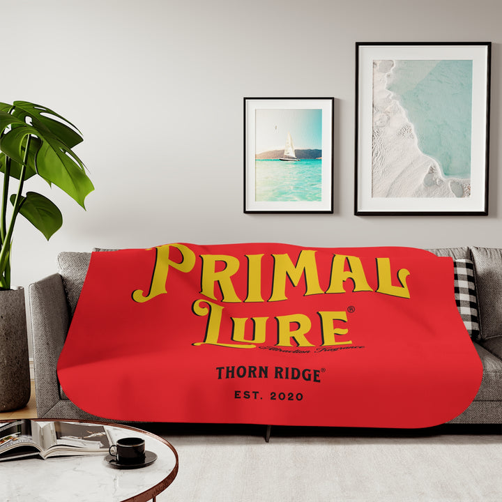 Prinmal Lure Attraction Fragrance by Thorn Ridge® in gold on a red sherpa blanket