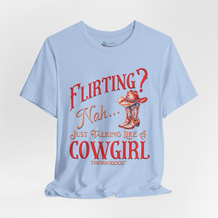 "Flirting? Nah... just talking like a cowgirl" graphic tee with women's cowgirl boots with a cowgirl hat sitting on top. Labeled Thorn Ridge®