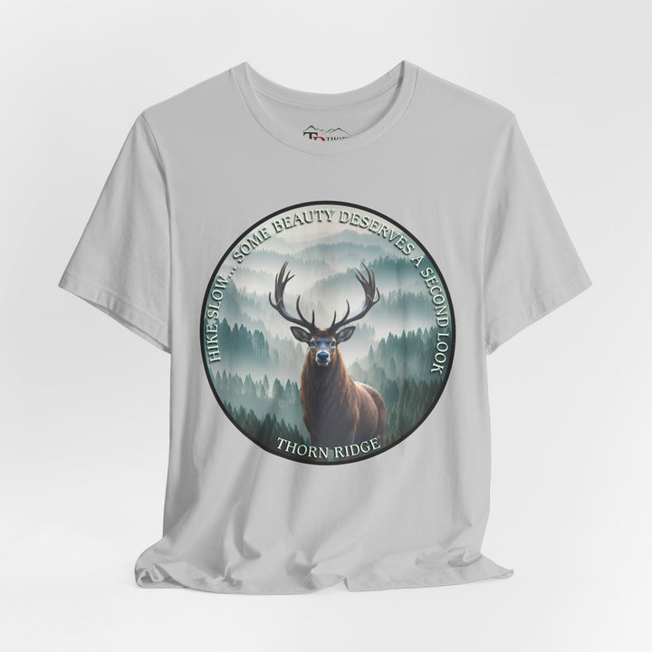 Hike Slow Some Beauty Deserves a Second Look tee with deer and mountains within a circular graphic by Thorn Ridge®