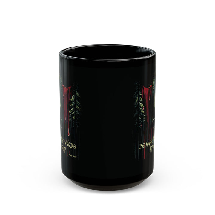 Black mug with a face emerging from the forest with bleeding eyes and a warning Beware the Woods at Night by Thorn Ridge®