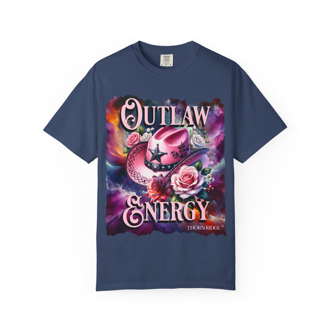 Outlaw Energy graphic tee with a pink cowgirl hat and roses on a celestial background of pinks, blues, and oranges. Labeled Thorn Ridge®