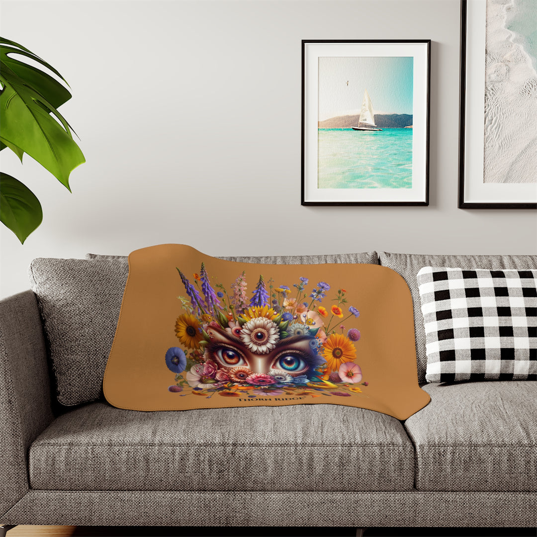 Colorful floral design with eyes on a brown background, featuring the brand 'Thorn Ridge'.