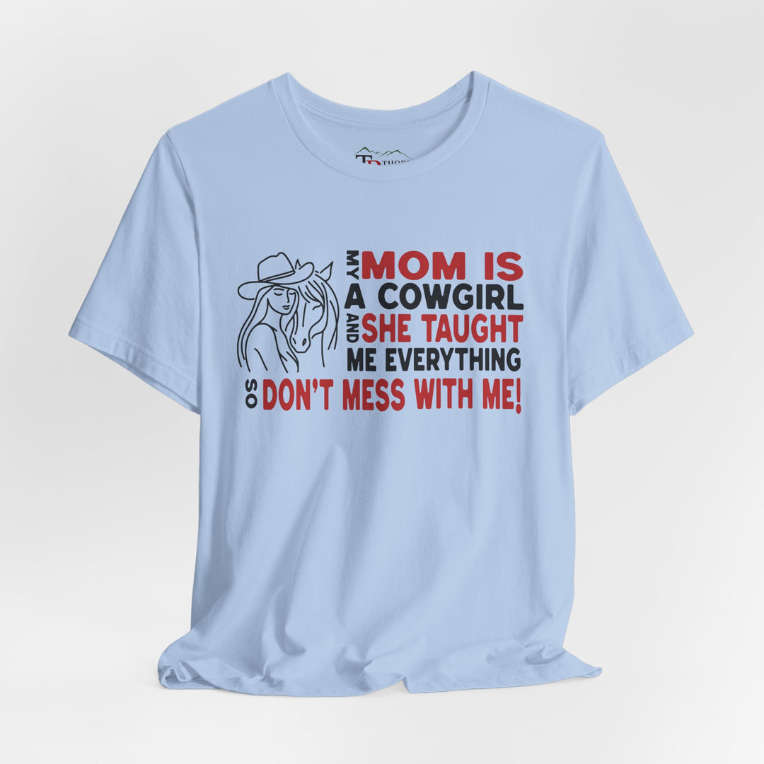 Mom is a cowgirl saying with neck label that says Thorn Ridge. Drawing of a girl and horse beside text. 