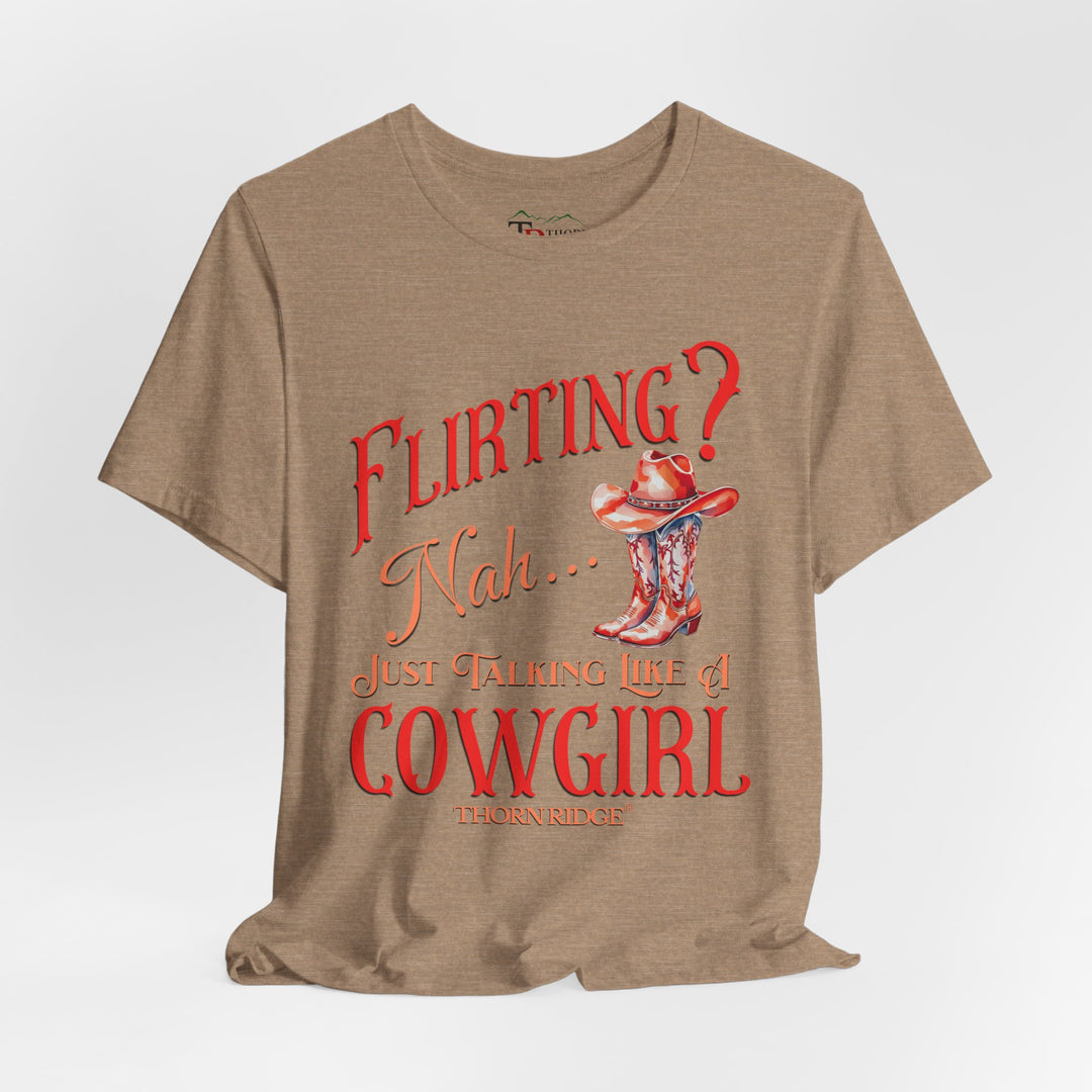 "Flirting? Nah... just talking like a cowgirl" graphic tee with women's cowgirl boots with a cowgirl hat sitting on top. Labeled Thorn Ridge®