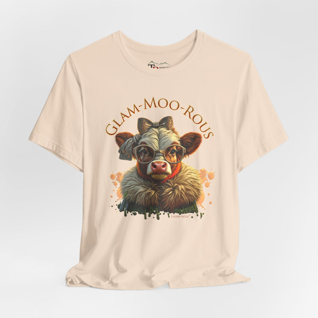"Glam-Moo-Rous" Graphic Tee with a  Cow in brown tones with sunglasses and bows on her head and a boa around her neck. Labeled Thorn Ridge®