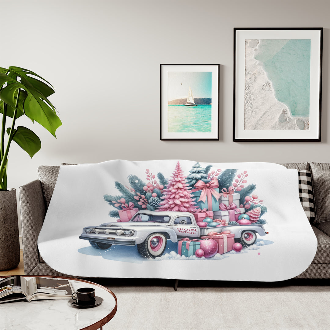 Vintage truck decorated with Christmas trees and presents on a white background with Thorn Ridge® branding on the door. Lying across a couch with a plant and pictures on the wall.
