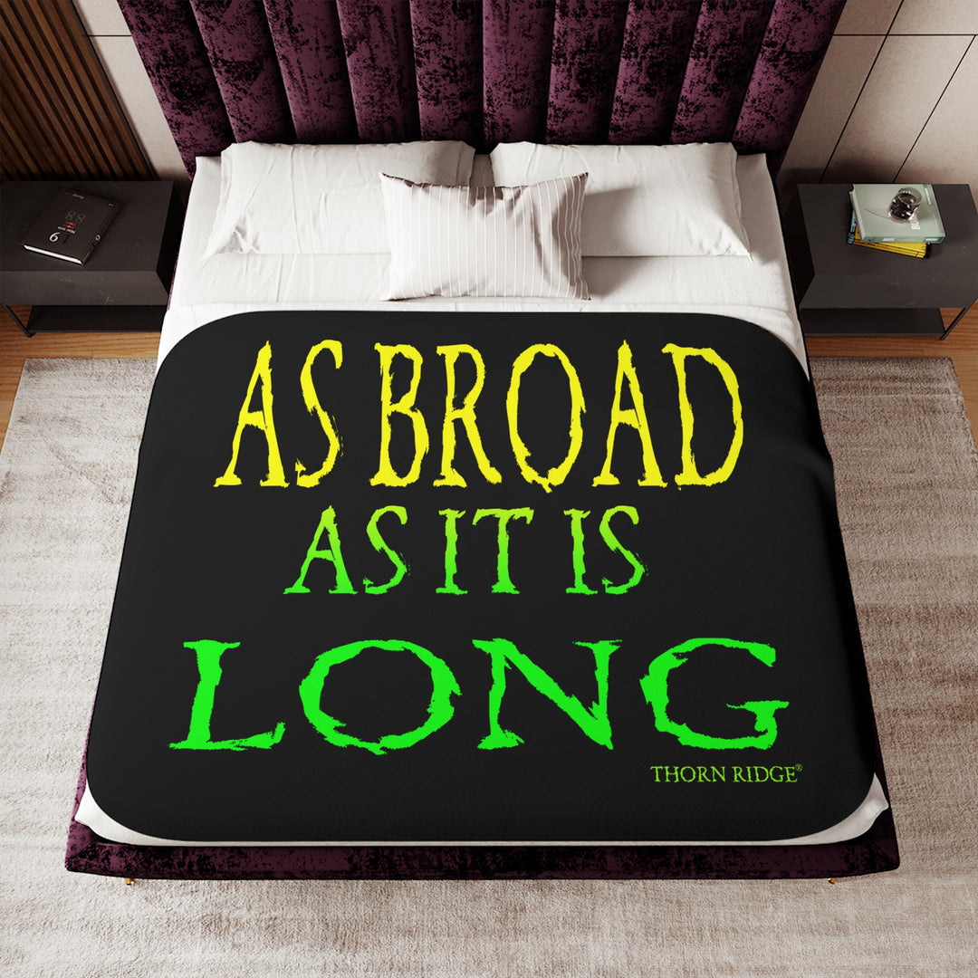 Black sherpa blanket with yellow and green text 'AS BROAD AS IT IS LONG' and 'THORN RIDGE' branding.