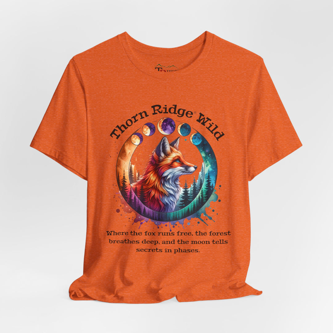 Thorn Ridge Wild Graphic Tee featuring a fox, forest, and moon phases. 