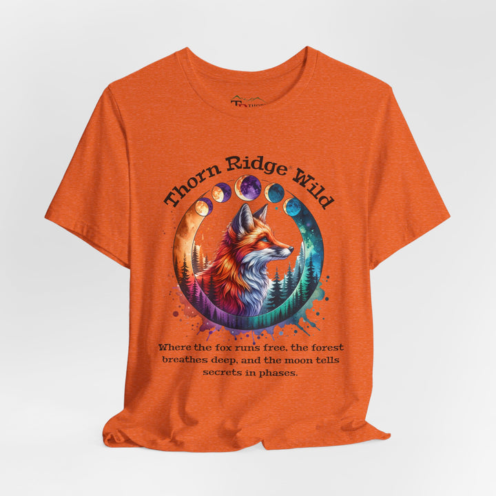 Thorn Ridge Wild Graphic Tee featuring a fox, forest, and moon phases. 
