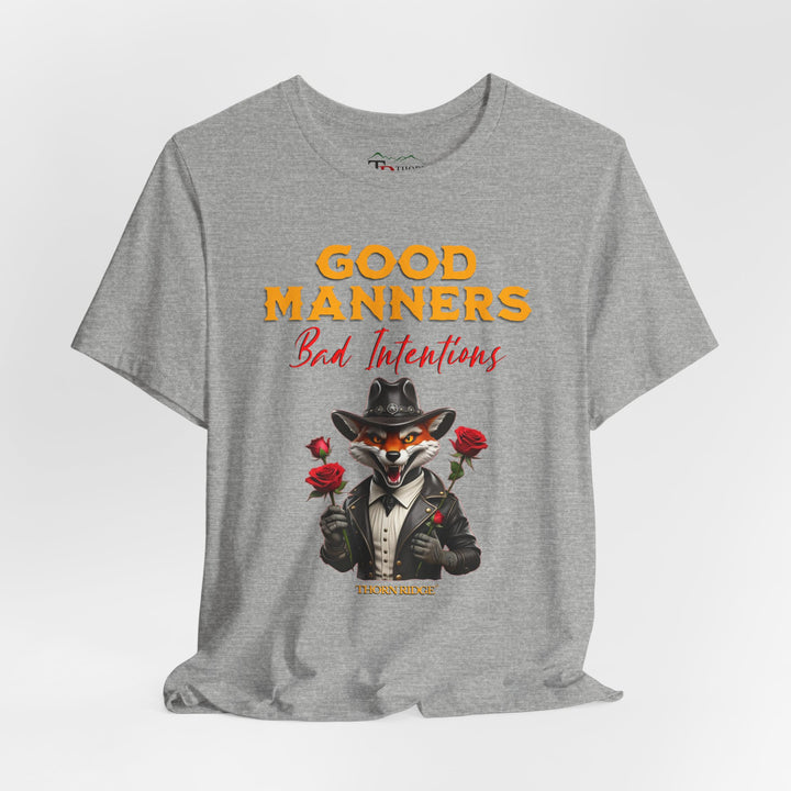 Good manners bad intentions graphic tee with a grinning fox wearing a black cowboy hat and leather jacket with human hands holding roses.  labeled Thorn Ridge®