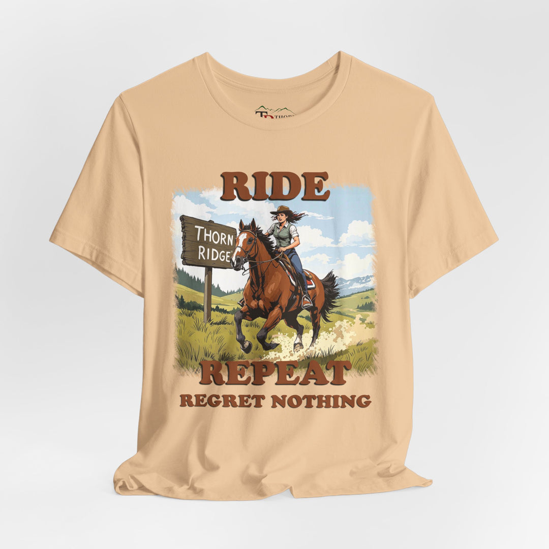 Ride Repeat Regret Nothing tee with a woman riding a galloping horse across the feild with the mountains in the background and a sign labeled Thorn Ridge®