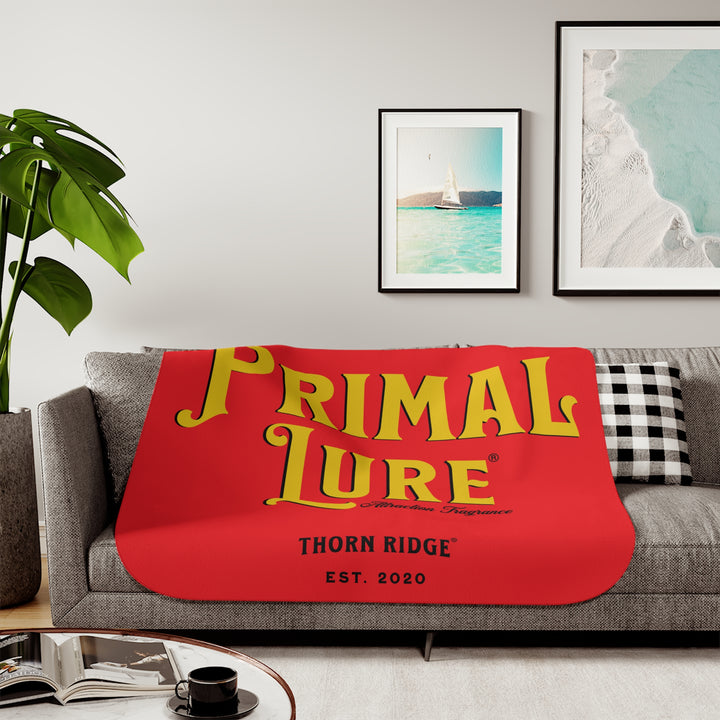 Prinmal Lure Attraction Fragrance by Thorn Ridge® in gold on a red sherpa blanket